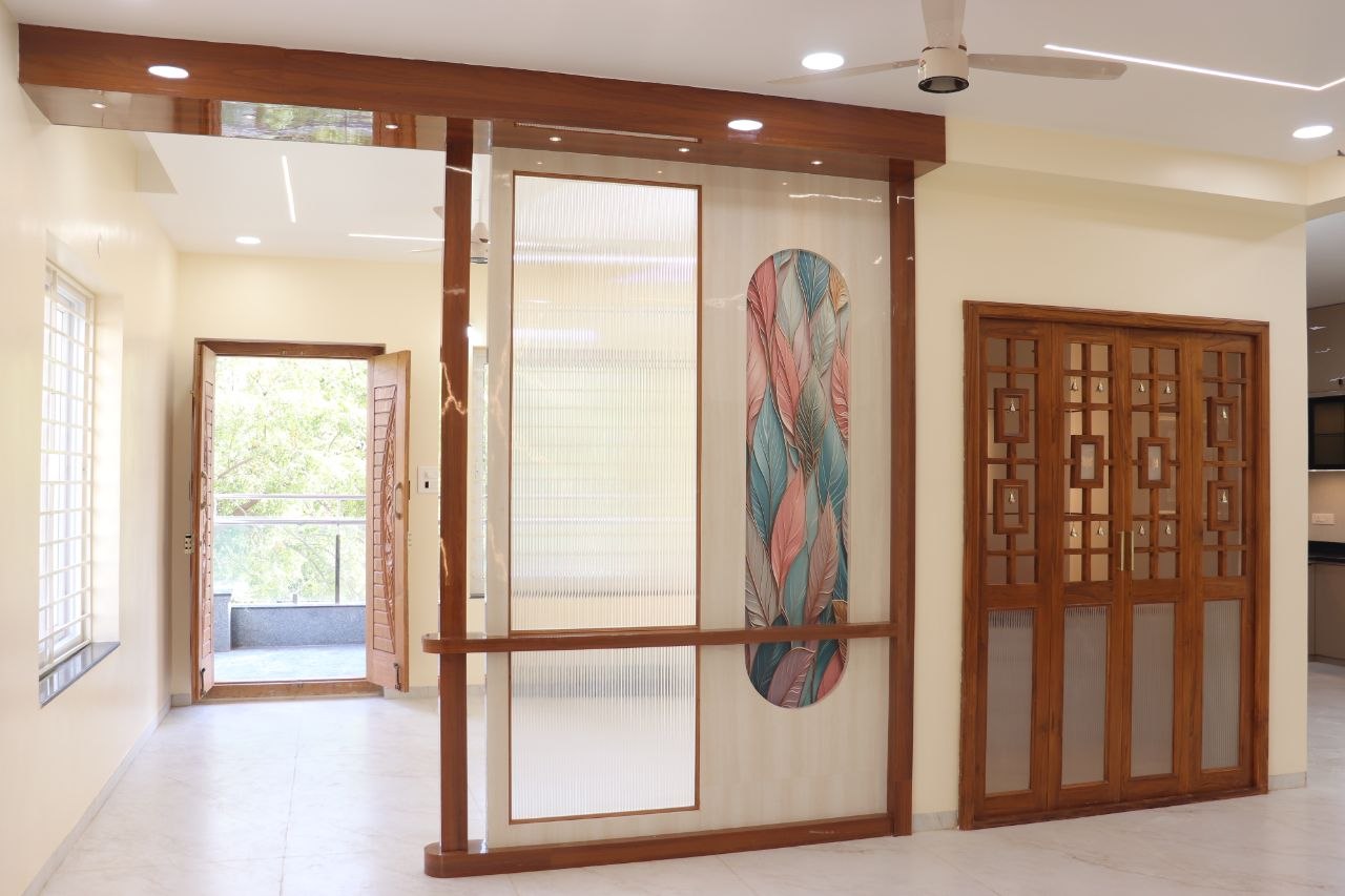 Full-home renovation foyer with wooden partition, reeded glass and printed art panel — by Vinterior Hub, Hyderabad